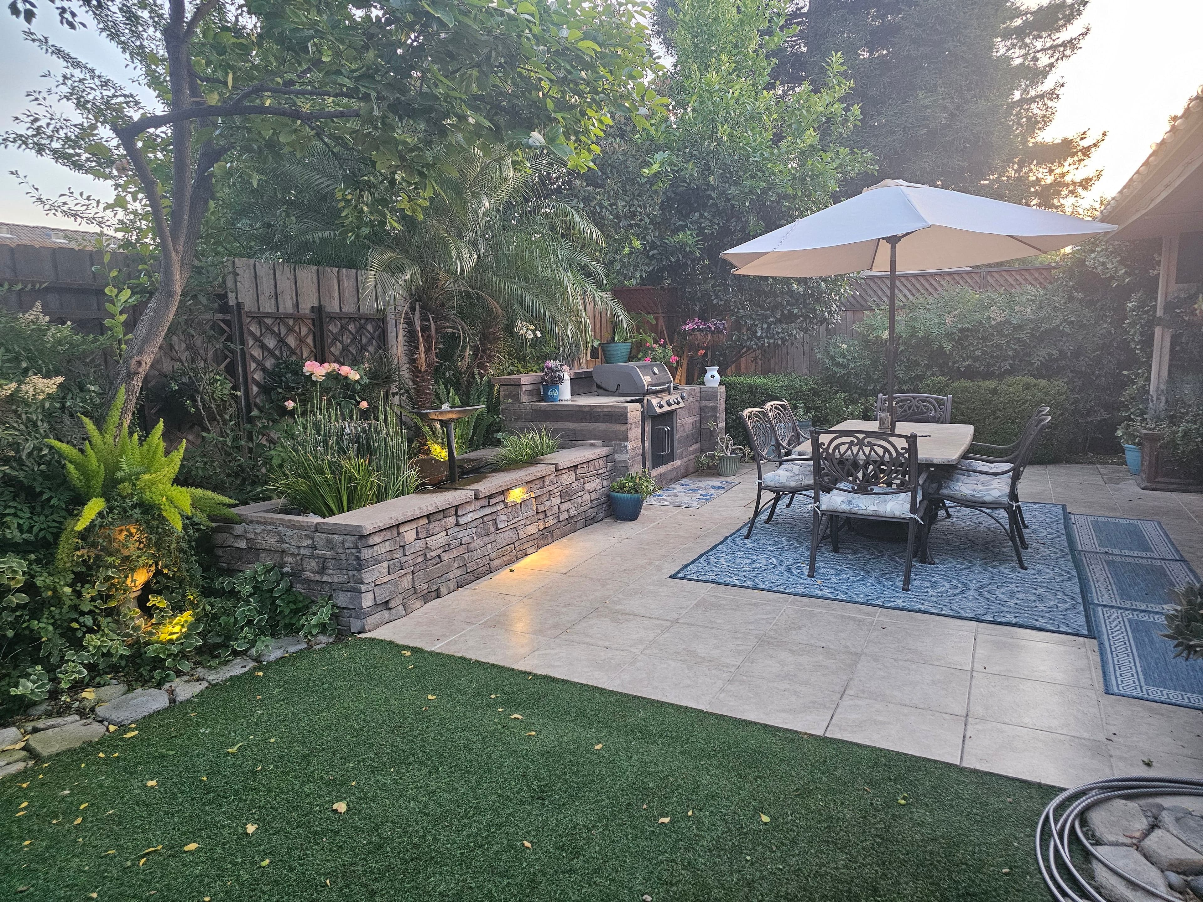 Project Small Backyard Packed With a Patio, BBQ Island, and Water Feature image