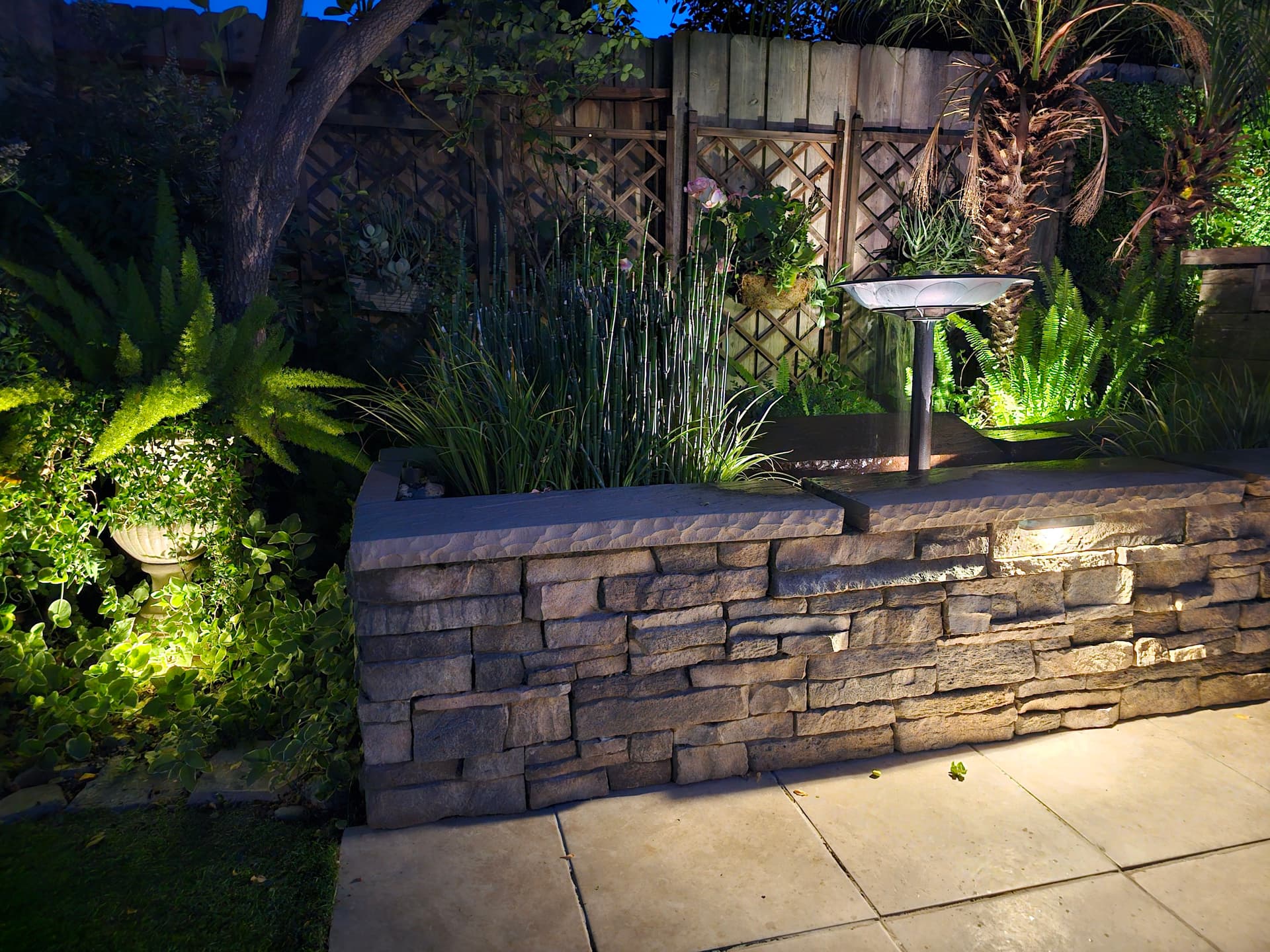 Stone Planter Wall and Patio That Brings the Backyard to Life image